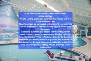 a sign in a swimming pool with a slide at Cozy 3 bedroom caravan near Edinburgh, 61 StAndrews at Seton Sands Holiday Village in Port Seton