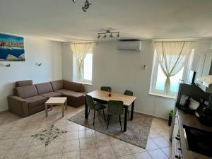 a living room with a couch and a table at Blue Coast Ivo in Piran