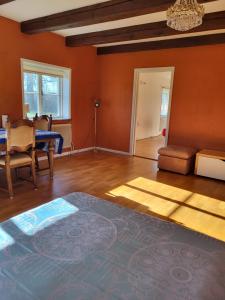a living room with orange walls and a rug at Torseke Hostel in Kristianstad
