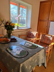 a dining room with a table and chairs and a window at Torseke Hostel in Kristianstad +10 photos