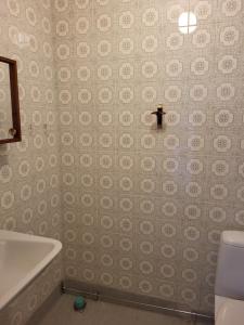 a bathroom with a toilet and a sink and a tub at Torseke Hostel in Kristianstad
