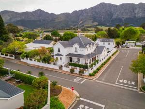 an aerial view of a house with mountains in the background at Le Petit Paris in Franschhoek