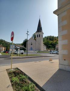 an intersection with a church with a stop sign at Keo Home in Arbent