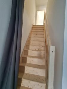 a staircase in a room with a blue curtain at Keo Home in Arbent