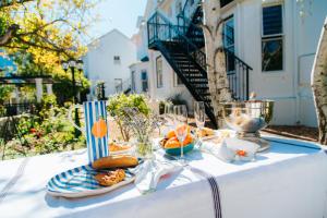 a white table with a plate of food on it at Le Petit Paris in Franschhoek