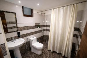 a bathroom with a toilet and a sink at Bajoon homestay in Bhīm Tāl