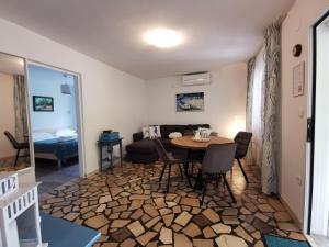 a living room with a table and a couch at Apartman Magdalena in Cres