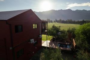 an aerial view of a red house with a balcony at Glorious Stay in Porterville