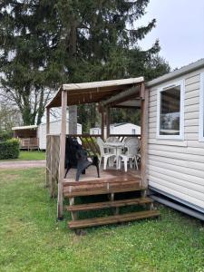 a wooden deck with a gazebo next to a house at Schilke24 - A017 in Boofzheim