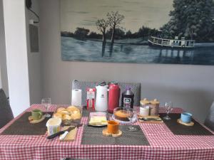 a table with a checkered table cloth with food on it at Hostel caminho da Serra in São Pedro +6 photos
