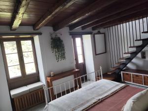a bedroom with a bed and a staircase with windows at Casa Julián in Garafía