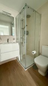 a bathroom with a shower and a toilet and a sink at Azahar Home Sevilla in Seville