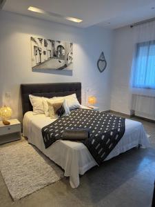 a bedroom with a large bed and a picture on the wall at La Penélope in Tunis