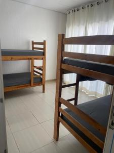 a room with two bunk beds and a window at Casa para 8 pessoas in Itu