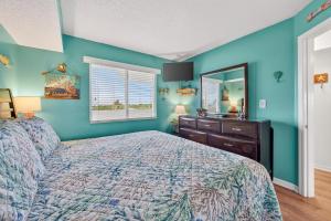 a bedroom with a bed and a dresser and a mirror at 6405 Gulf Shores Plantation-Palms in Gulf Shores +30 photos
