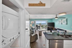 a kitchen and living room with a view of the ocean at 6405 Gulf Shores Plantation-Palms in Gulf Shores