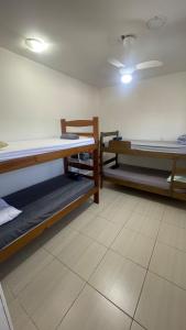 a room with three bunk beds in it at Casa para 8 pessoas in Itu
