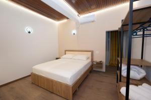 a bedroom with a bed and a bunk bed at Bar Hotel Orgito in Lushnjë