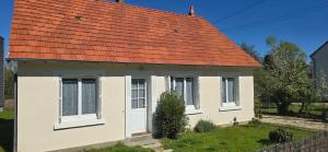 a small white house with an orange roof at Gîte La Bracilienne in Bracieux