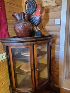 a wooden table with two vases and a chicken on it at Cosy Village in Šentjernej