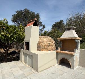 a small house with a roof on a patio at Villa Lonaki in Haraki