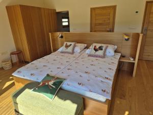 a bedroom with a large bed with a wooden headboard at Cosy Village in Šentjernej