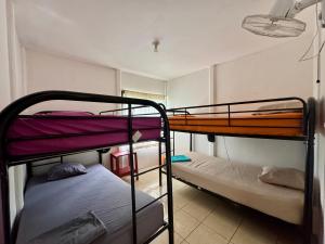 a room with two bunk beds in a room at Kalunay Hostel - Breakfast included in Puerto Viejo