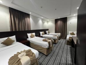 a hotel room with three beds in a room at فندق اسفار الحجاز 2 in Al Masfalah +64 photos