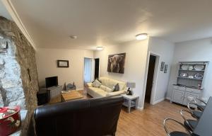 a living room with a couch and a table at The Old Stable, Llancarfan in Llancarvan