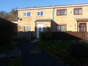 a brick house with a driveway in front of it at Luxurious Dingle Corner in Bristol