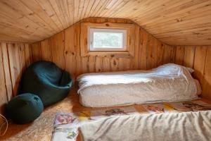 a small room with two beds and a window at Midgard in Osiecznica