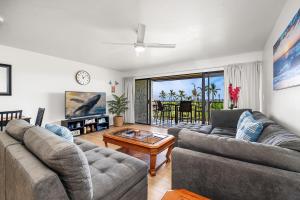 a living room with two couches and a table at Keauhou Punahele#B-207 in Kailua-Kona