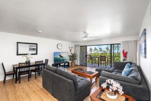a living room with two couches and a table at Keauhou Punahele#B-207 in Kailua-Kona