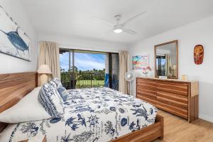 a bedroom with a bed and a window at Keauhou Punahele#B-207 in Kailua-Kona +35 photos