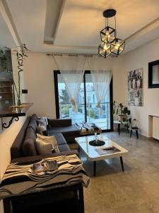 a living room with a couch and a table at La Penélope in Tunis