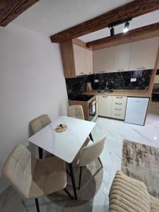 a white dining table and chairs in a kitchen at Sunrise Skadar lake in Braćeni +17 photos