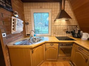 a kitchen with a sink and a window at Ferienhaus am Mescheriner See in Mescherin +54 photos