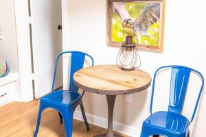 two blue chairs and a table with a lamp on it at Above the Trees - Modern Studio for 2 with Views, Wifi, Pools in Gatlinburg
