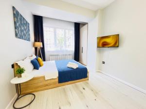 a small bedroom with a bed and a window at 417I2 Gray and Yellow apartment Sholpan city in Almaty +15 photos