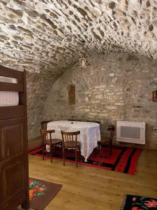 a dining room with a table and chairs in a building at Jeanette's Home in Berat