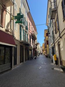 an empty street in a city with buildings at Chiara 3 in Cairo Montenotte +1 photo