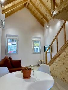 a living room with a white table and chairs at Rosea LOFT in Përmet