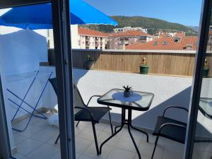 a small table and chairs on a balcony at City Suites Budva in Budva