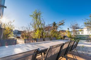 a long wooden table and chairs in a yard at Sky Garden Vienna in Vienna +67 photos
