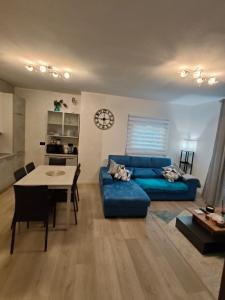 a living room with a blue couch and a table at Dimora di Teglio in Teglio