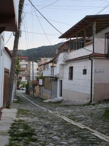 an empty street in a city with buildings at Jeanette's Home in Berat