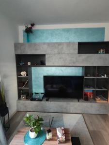 a living room with a fireplace and a table at Dimora di Teglio in Teglio