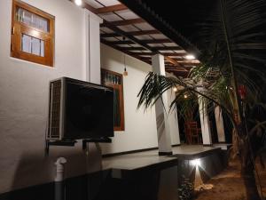 a tv hanging on the side of a building at Nature Velora Villa in Tangalle