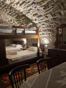 a bedroom with two bunk beds in a stone wall at Jeanette's Home in Berat