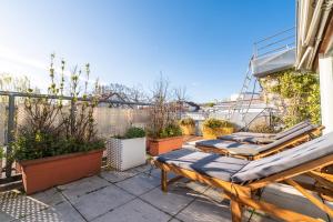 a patio with chaise lounges and plants at Sky Garden Vienna in Vienna